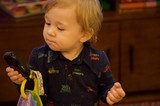 Toddler Examining Dark Green Vegetable with Curiosity