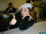 Stylish Woman in Hat Enjoying a Meal with Friends