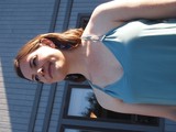 Young Woman in Teal Dress at Outdoor Event