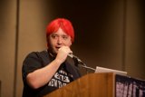 Red-Haired Speaker Addressing the Crowd