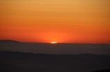 Last Light: Sun Swallowed by Mountain Ridgeline