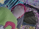 Baby's First Carnival Experience Under Colorful Lights