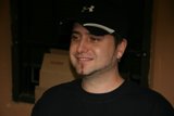 Black Shirted Man Wearing a Baseball Cap