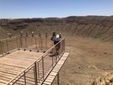Taking in the View: Girl Stands on Crater's Edge