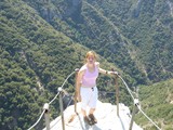 Fearless Woman Stands at Mountain Viewpoint Edge