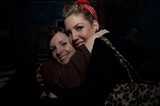 Two Friends Share a Warm Embrace at Night