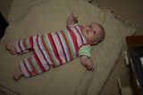 Bright-Eyed Baby Resting on Cozy Knit Blanket