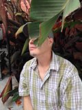 Hat-Topped Man Amid Foliage