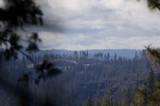 Smoke Drifts Over Burned Forest Ridgeline