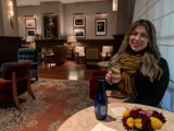 Woman enjoying a glass of wine on a cozy evening