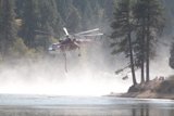 Helicopter Fighting Wildfires Over River