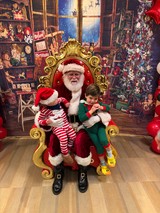 Two Children Visit Santa in His Workshop Grotto