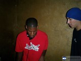 Two Men Posing for a Portrait in Hats and Headphones