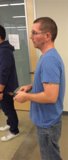 Man in Blue Shirt with Remote Control