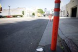 Lone Traffic Cone on a Busy Urban Street