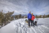 Summit Smiles: Couple Atop Snowy Sierra Nevada Peak