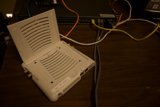 White Computer Connected to a Tangle of Wires