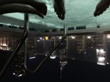 Nighttime Reflections in the City Caption: The serene waters of the jacuzzi provide the perfect spot for some peaceful reflection amidst the towering skyscrapers of the urban metropolis.