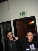 Two Men Posing in Front of a Door