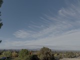 Suburban Valley View with Wispy Cloud Formations