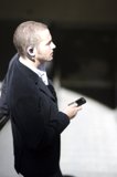 Businessman on the Phone Caption: A suited man stays connected with his cell phone during a business shoot for Flexilis.