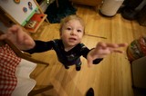 Toddler Reaching Up During Christmas Morning at Home