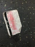 Red Sticker on Paper