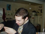 Man Enjoying a Sandwich in Formal Wear