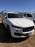White Maserati Surrounded by Black Cars