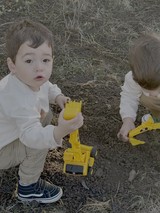 Children Playing with Toy Construction Trucks Outdoors