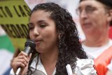 A Woman's Voice Caption: The power of a microphone in a woman's hand as she addresses the crowd during the 2007 Great American Boycott.