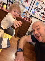 Father and Toddler Selfie at Festive Dining Table