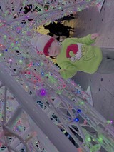 Child Playing in Reflective Metallic Installation Art