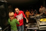 Green-shirted DJ spins tunes at nightclub