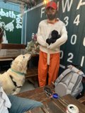 Man in Orange Pants Poses Amongst Wood