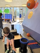 Child Exploring Interactive Science Exhibit at Museum