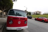 Classic Red and White VW Bus on the Side of the Road