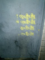 Bold Yellow Graffiti on Building Wall