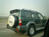 Green SUV tearing up the highway