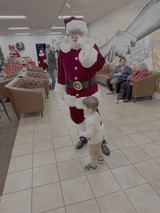 Santa Meets Young Child at Christmas Event
