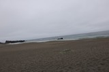 Overcast Coastal Beach with Rocky Shoreline