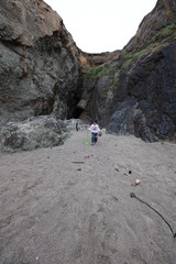 Young Explorer in a Rocky Coastal Canyon