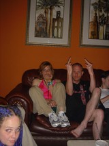 Friends Lounging on Leather Couch at Indoor Gathering