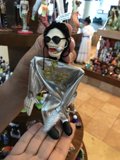 Silver Skeleton Figurine Held by a Woman