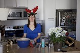 Holiday Hostess with Reindeer Antlers in Kitchen
