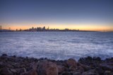 Shimmering Skyline on a Rocky Shoreline