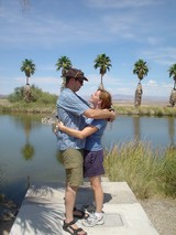 Couple Embracing at Desert Oasis Pond