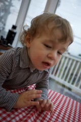 Toddler Engaged in Focused Hand Activity at Table