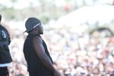 Bandana-wearing man in a sea of baseball caps
