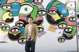 Staring Back: A Man Confronts a Wall of Eyes